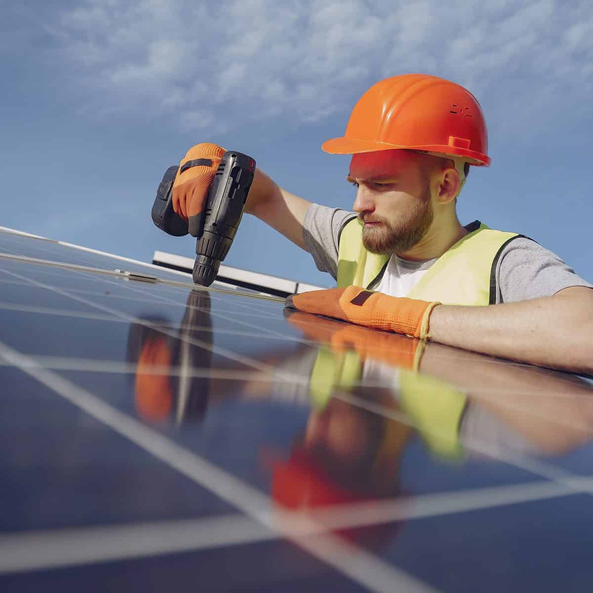 An electrician installing a solar panel