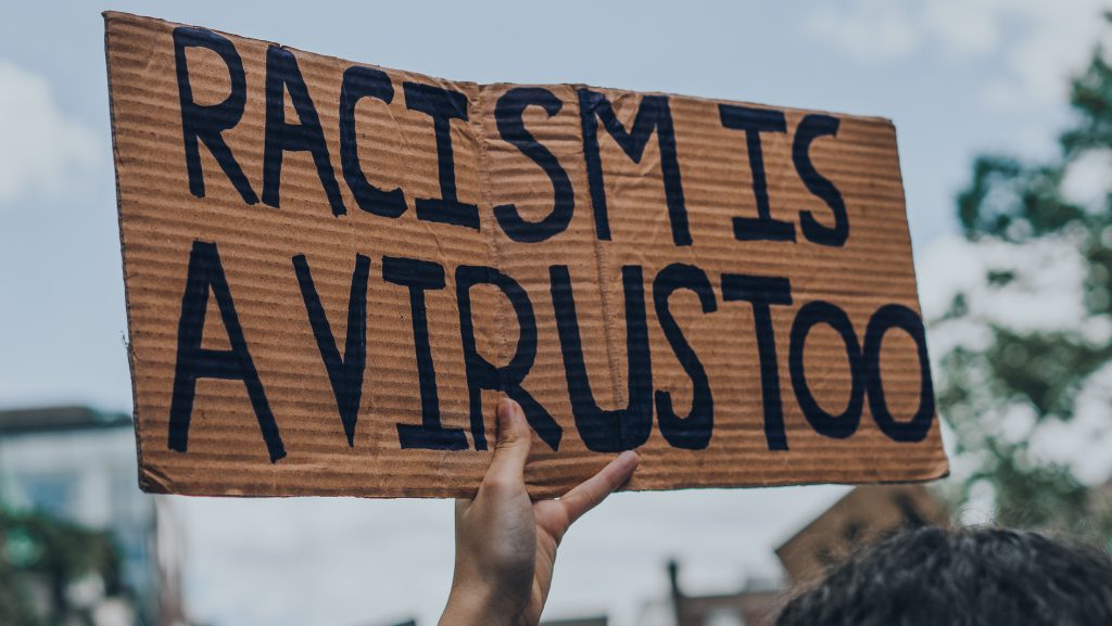 Black lives matter prostest in montreal, racism is a virus sign.