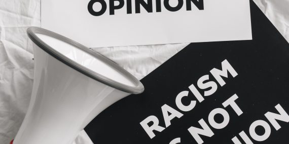 Megaphone and placards on racism on white linen