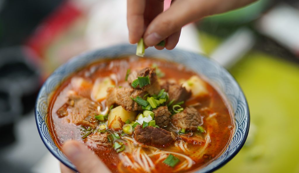 Noodles soup with meat on bowl