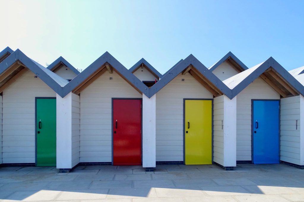 The colourful beach huts, along the seafront at Swanage Dorset.  Some people use these colours to teach behaviour.