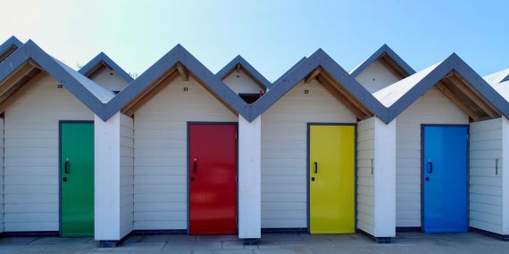 The colourful beach huts, along the seafront at Swanage Dorset.  Some people use these colours to teach behaviour.