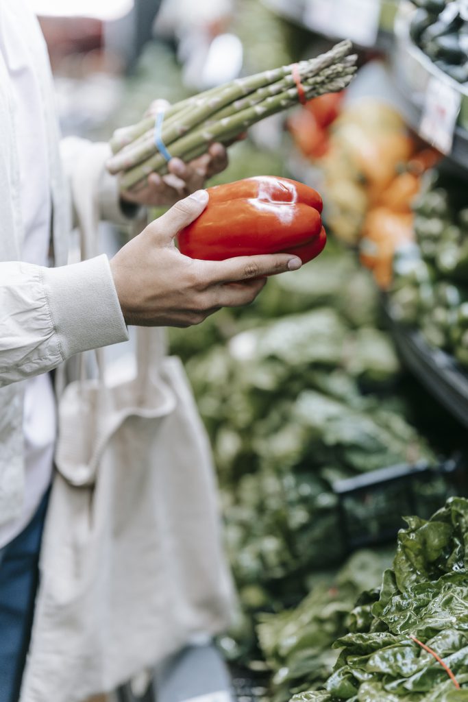 Unrecognizable customer choosing vegetables in supermarket