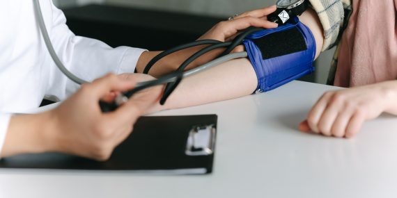 A healthcare worker measuring a patient s blood pressure using a sphygmomanometer