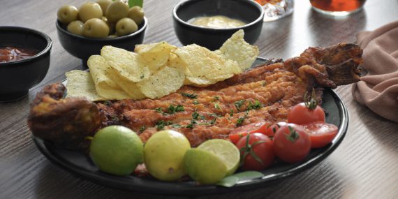 Delicious fried fish and potato chips with salsas
