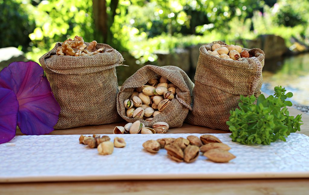 Sacks with assorted nuts placed on table in nature