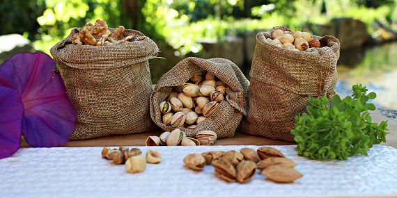 Sacks with assorted nuts placed on table in nature