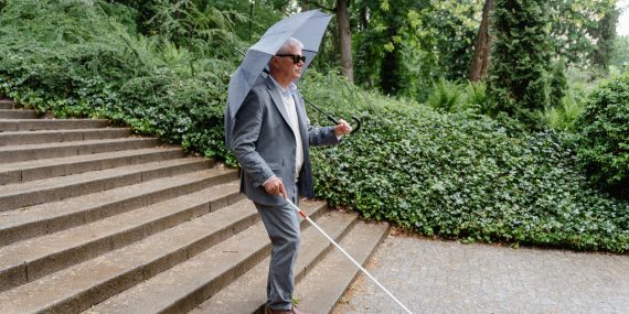 A blind man using a walking stick