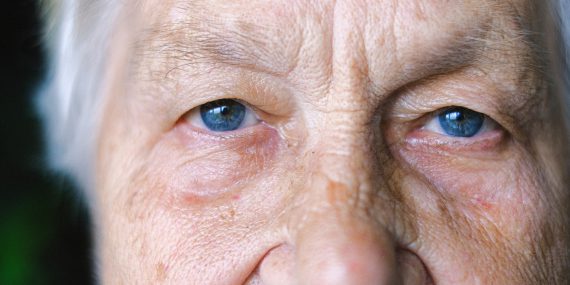 Crop elderly woman with blue eyes