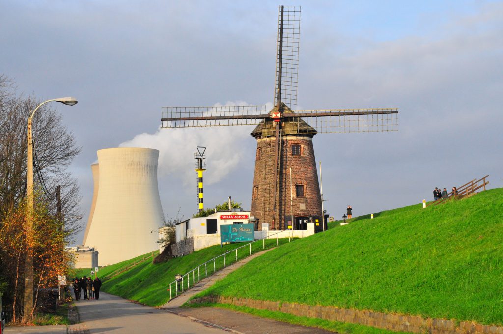 This old windmill is located near a power plant, of which you can see the cooling towers in the background.