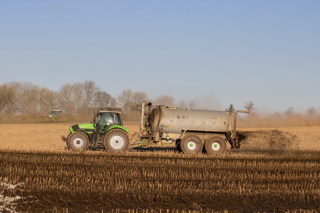 Tractor delivering slurry onto a field