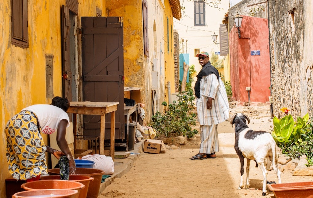 woman in white dress walking on street during daytime