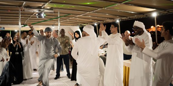 a group of people dressed in white dancing