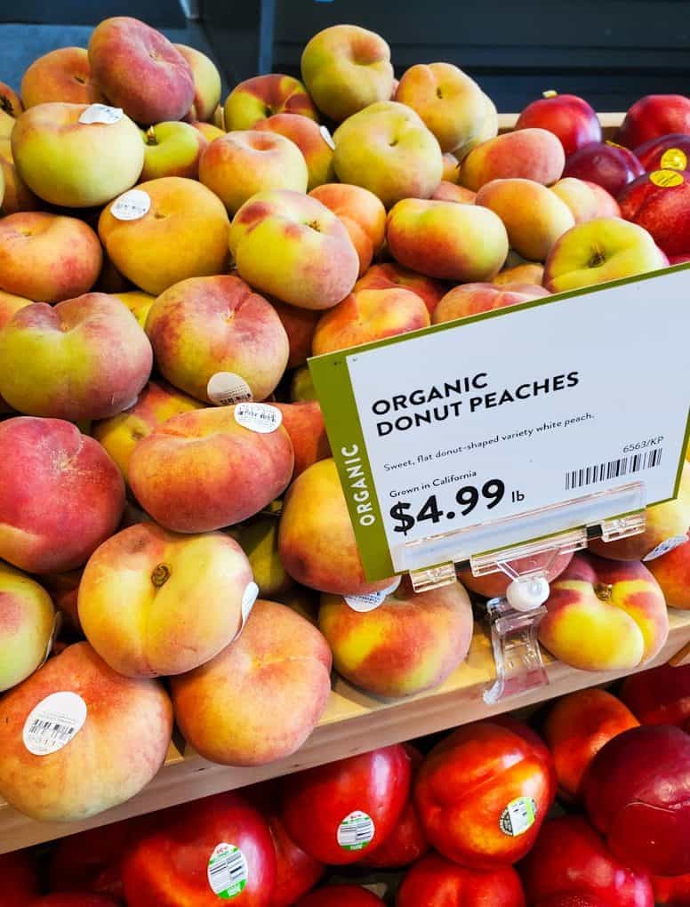 Fresh organic donut peaches displayed for sale.