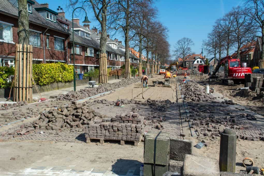 Construction of a brick-paved street in a residential neighborhood.