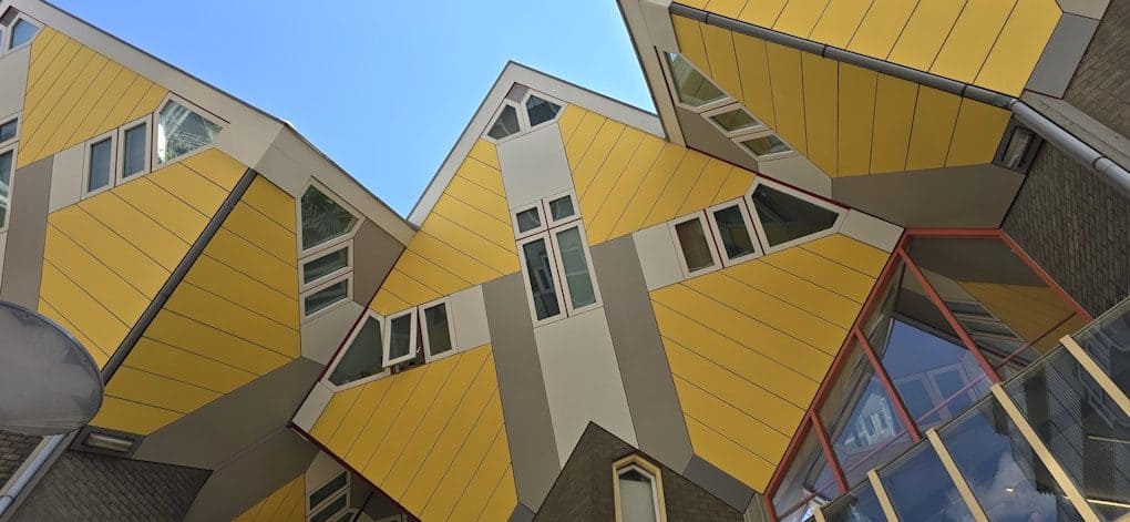 Unique cube-shaped houses under a clear blue sky.