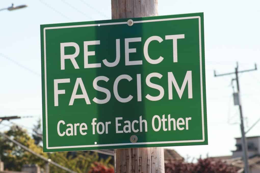 A green sign in Seattle promoting anti-fascism and community care.